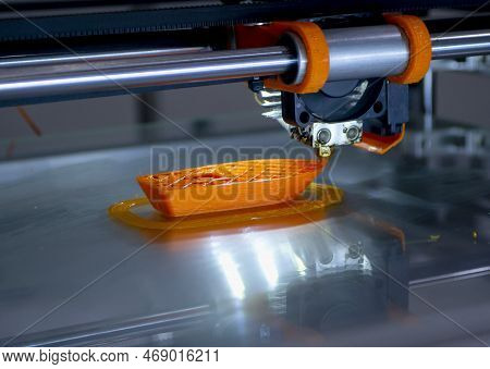 3d Printer Printing A Model Close-up. The Process Of Printing A Model On A 3d Printer Made Of Orange