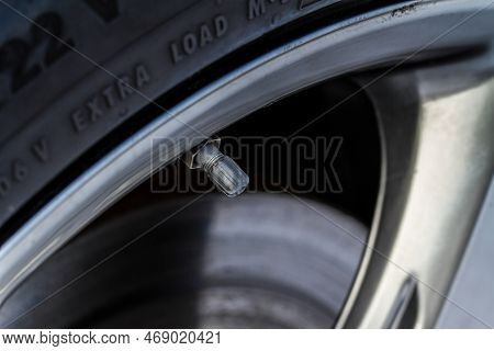 Tire Valve Cap On Modern Car Wheels. Close Up Of A New Car Tire Valve. Vent In The Wheel Of A Car.