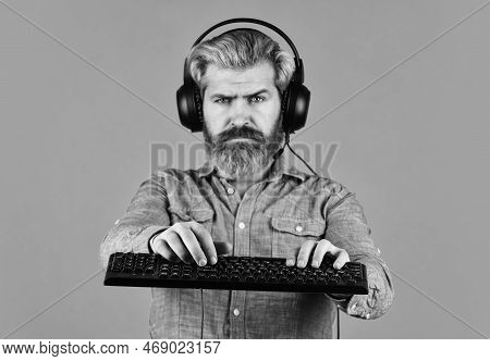 Agile Business. Downloading Music From Internet. Bearded Man Headphones And Keyboard. Professional G