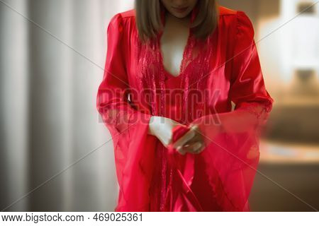 Blurred Soft Of The Asian Woman Wearing A Red Silk Robe.