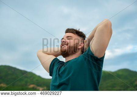 Happy Handsome Free Guy, Young Calm Relaxed Carefree Man Traveler With Open Raised Hands Enjoy Mount