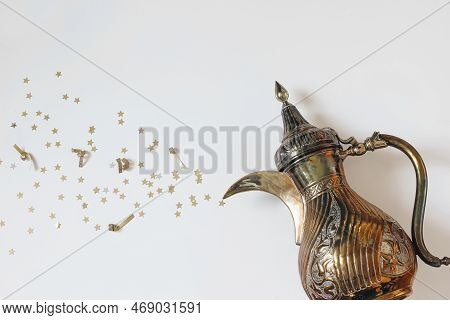 Ramadan Kareem Still Life. Traditional Ornamental Arabic Dallah Coffee Pot With Bursting Golden Star