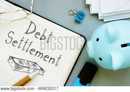Debt Settlement Is Shown On A Business Photo Using The Text