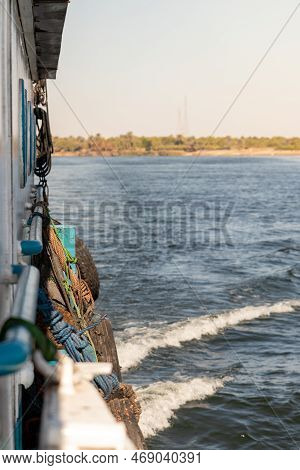 Vertical View Of Side Traditional Local Boat Sailing The River In Natural Enviroment