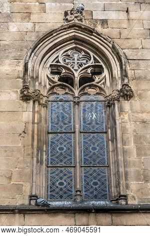 Old Stained Glass Arched Window Of The Capella De Santa Llucia Chapel - View From Placa De Garriga I