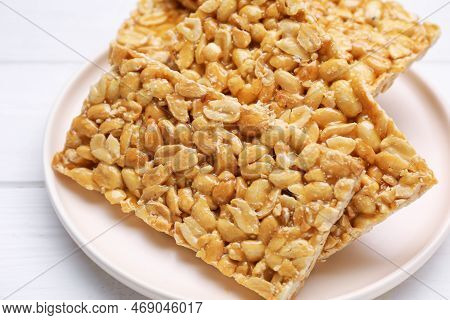Delicious Peanut Bars (kozinaki) On White Wooden Table, Closeup