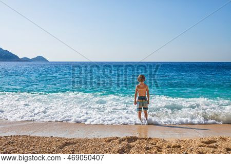 Happy Child Looking At Turquoise Sea Water At Kaputas Beach, Lycia Coast. Summer Relaxing Day At Fam