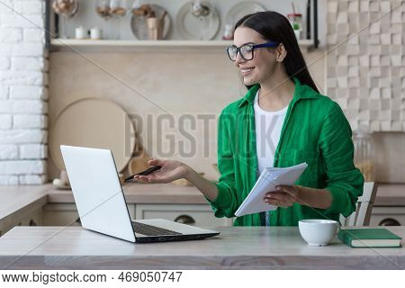 A Young Female Student, A Freelancer Studies, Works Online At Home From A Laptop. He Sits At The Tab