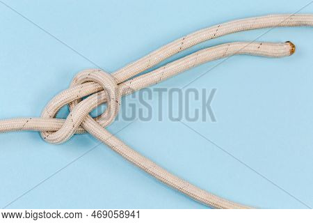 Rope Knot Bowline, Or Boling Knot Close-up On A Blue Background