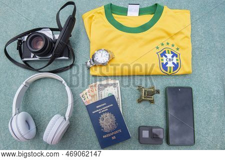 11 Jan 2023: Bauru, Brazil: Antique Camera, Silver Wristwatch, Brazilian Soccer Team T-shirt, Headph