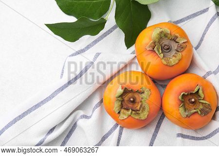 Delicious Ripe Juicy Persimmons On Light Table, Flar Lay