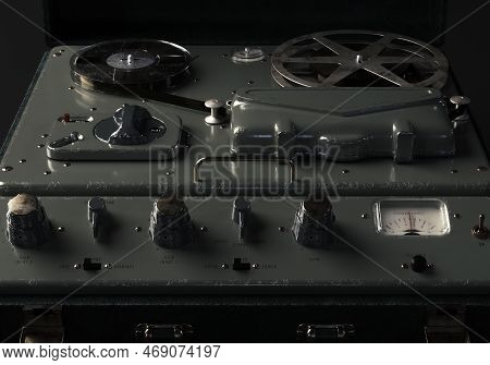 A Vintage Reel-to-reel Analogue Analogue Audio Recorder In A Leather Case On A Dark Moody Studio Bac