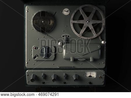 A Vintage Reel-to-reel Analogue Analogue Audio Recorder In A Leather Case On A Dark Moody Studio Bac