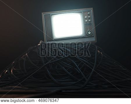 An Illuminated Vintage 80's Television Perched On A Jumbled Pile Of Black Cables On A Dark Omnious B