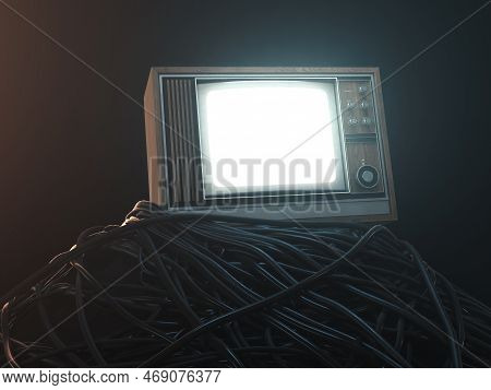 An Illuminated Vintage 80's Television Perched On A Jumbled Pile Of Black Cables On A Dark Omnious B