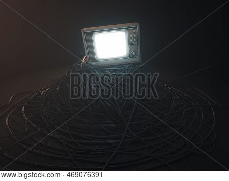 An Illuminated Vintage 80's Television Perched On A Jumbled Pile Of Black Cables On A Dark Omnious B