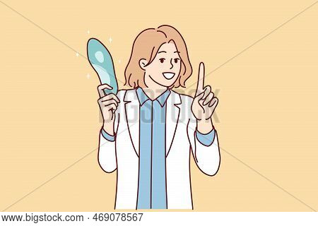 Female Doctor In White Coat Holding Blue Object Giving Recommendation To Patient On Use Of Medical D