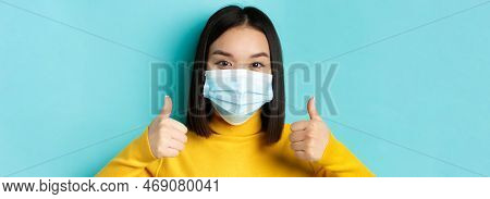 Covid-19, Social Distancing And Pandemic Concept. Close Up Of Young Asian Woman In Medical Mask Show