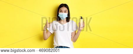 Covid, Health Care And Pandemic Concept. Asian Girl In Face Mask From Coronavirus, Pointing Finger A