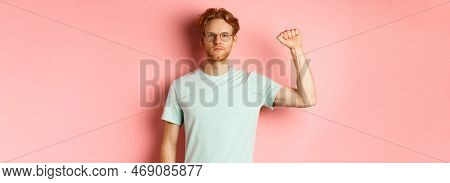 Confident Redhead Man Standing United With Black Lives Matter Movemet, Showing Raised Fist And Looki
