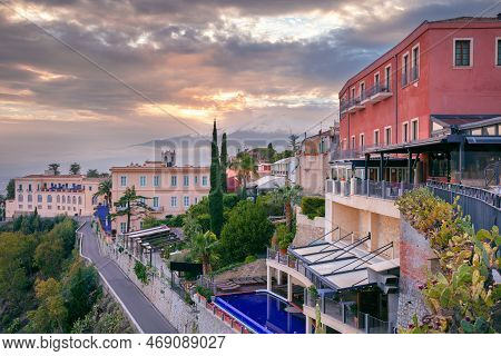 Taormina, Sicily, Italy. Cityscape Image Of Picturesque Town Of Taormina, Sicily With Volcano Mt. Et
