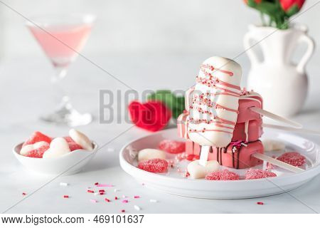 Decorated Cakesicles On A Plate For Valentines Day With Candy And Sprinkles.