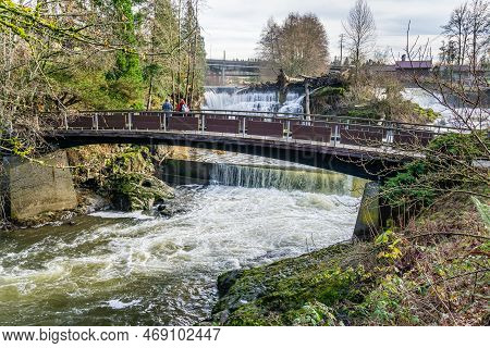 A View Of A Walking Bridges And Upper Tumwater Falls In Washington State.