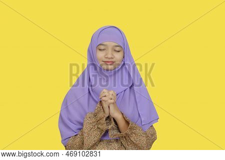 Portrait Young Girl Wear Purpel Hijab On Yellow Background.