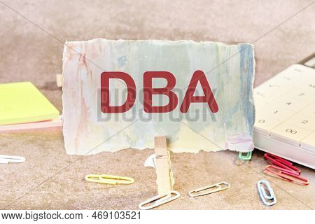 Dba Is A Word On Paper On The Table. Dba - Short For Doing Business As.
