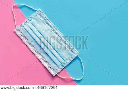 Ear Loop Face Mask Layers, Protective Masks On A Blue And Pink Background. Dust Protection Respirato