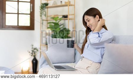 Woman using laptop to work or do homework at home with smiling face in her living room, Creating hap