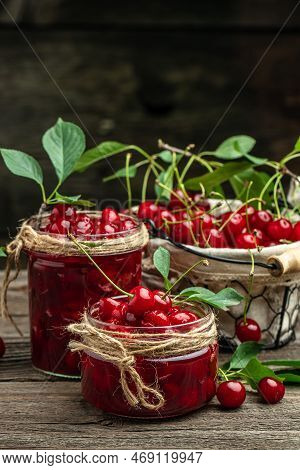 Jar Of Cherry Jam And Sour Cherries. Berries Cherry With Syrup. Ripe Ripe Cherries. Sweet Red Cherri