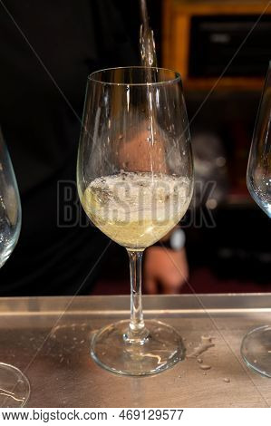 Pouring Of Txakoli Or Chacolí Slightly Sparkling Very Dry White Wine Produced In Spanish Basque Coun
