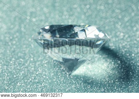 Beautiful Dazzling Diamond On Shiny Glitter Background, Closeup. Precious Gemstone