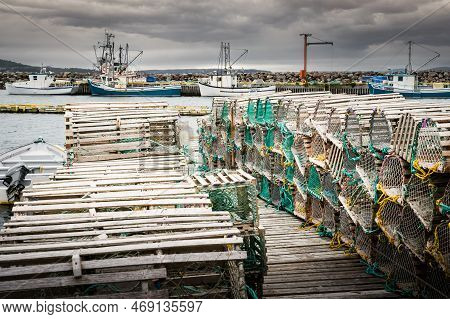 Whiteway Newfoundland Canada, September 25 2022: Wooden Lobster Traps Neatly Stacked On A Dock With 