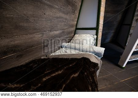 Single Bed With Clean Linen In Bedroom Niche Of Wooden Cabin. Pyramid Shape Bungalow Summer House. A