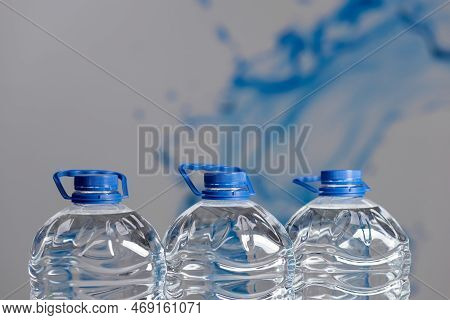 Three 5 Liter Plastic Water Bottles Close Up. Water Delivery
