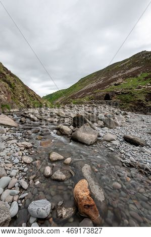 Long Exposure Of The River Heddon Flowing Onto The Beach At Heddons Mouth In Exmoor