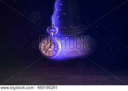 Hypnosis Session. Vintage Pocket Watch With Chain Swinging Over Surface On Dark Background Among Fad