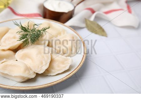 Cooked Dumplings (varenyky) With Tasty Filling And Dill On White Table, Closeup. Space For Text