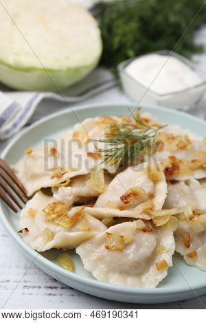 Cooked Dumplings (varenyky) With Tasty Filling, Fried Onions And Dill On Wooden Table, Closeup