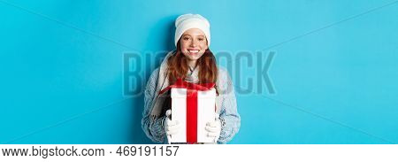 Winter Holidays And Christmas Sales Concept. Cute Redhead Teeanage Girl In Beanie, Sewater And Scarf