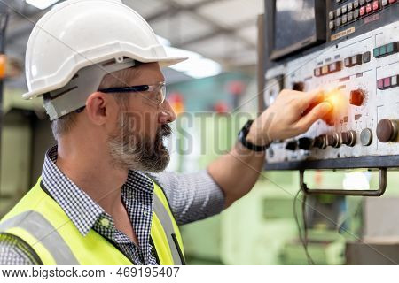 Industrial Man Man Engineer Wear Uniform And Helmet Are Checking System Machine At Factory. Manager 