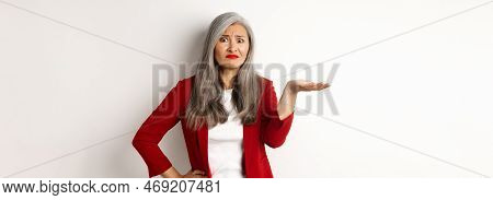 What Is This. Confused And Skeptical Asian Female Entrepreneur Pointing Hand At Something Strange, S