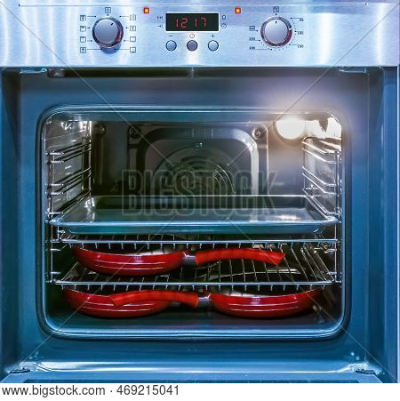 Close Up Of Demonstrating The Space Inside The Empty Electric Oven With Switched Inner Light