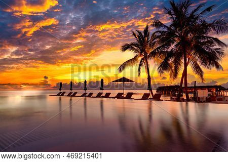 Sunrise Blue And Pink Light Scattering Across The Clouds And Pool, Reflecting The Infinity Pool And 