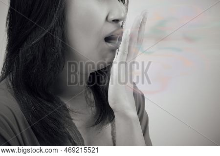 Asian Woman Close Her Mouth Against Gray Background, Bad Breath