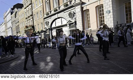 London - 02 27 2022: Girls Keep Dancing With Fourth Movement Of Shuffle Dance In Covent Garden With 