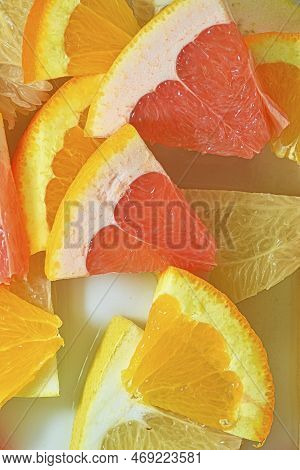 Slices Of Grapefruit, Orange And Pomelo In Water On White Background. Pieces Of Grapefruit, Orange F