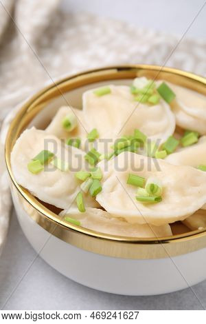 Cooked Dumplings (varenyky) With Tasty Filling And Green Onion On Light Table, Closeup